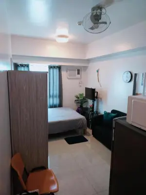 a living room with a bed and a couch at Sweet Kathleen at The Beacon Makati in Manila