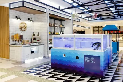 a store with a fish tank in the middle of a room at ibis Styles Manila Araneta City in Manila