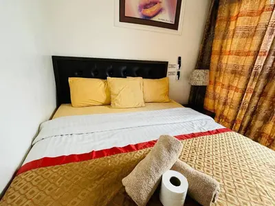 a bedroom with a bed with a roll of toilet paper at Birch Tower a1 front of RobinsonMla Rizal Park in Manila