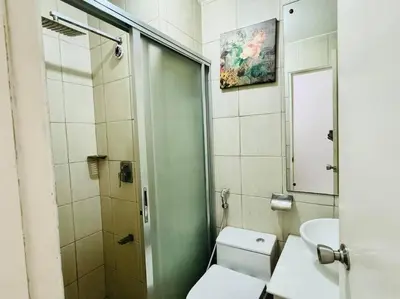 a bathroom with a toilet and a sink and a shower at Birch Tower a1 front of RobinsonMla Rizal Park in Manila