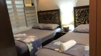 a bedroom with two beds and a window at 1BR Condo Unit W/ Fantastic View near US Embassy in Manila