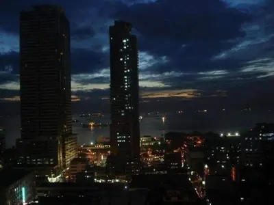 a city skyline at night with a tall building at 1BR Condo Unit W/ Fantastic View near US Embassy in Manila