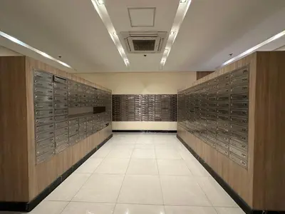 a hallway with wooden lockers in a building at 1 BR Uptown BGC Cozy Condo Netflix 200Mb Wi-Fi in Manila