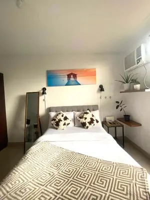 a bedroom with a large white bed with two pillows at Nature Inspired Cozy Studio Rooms Mandaluyong Near Edsa Shaw Shangri-La Megamall at F Residences in Manila