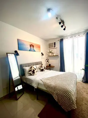 a bedroom with a bed with two pillows on it at Nature Inspired Cozy Studio Rooms Mandaluyong Near Edsa Shaw Shangri-La Megamall at F Residences in Manila