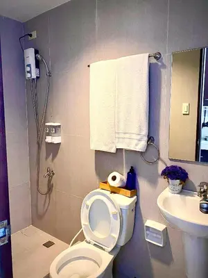 a bathroom with a shower and a toilet and a sink at Nature Inspired Cozy Studio Rooms Mandaluyong Near Edsa Shaw Shangri-La Megamall at F Residences in Manila