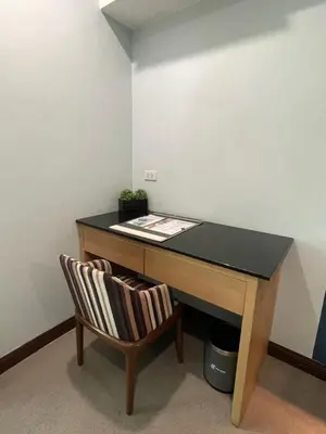a desk with a chair and a black counter at Homes at Bay Area Suites by SMS Hospitality in Manila