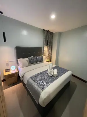 a bedroom with a bed with two stuffed animals on it at Homes at Bay Area Suites by SMS Hospitality in Manila