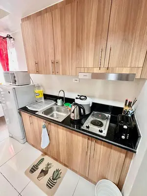 a small kitchen with a sink and a refrigerator at Apartment Seaside Bliss in Manila