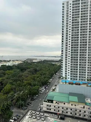 an aerial view of a large building with a parking lot at SMDC Coast Residences - The Happy Place in Manila