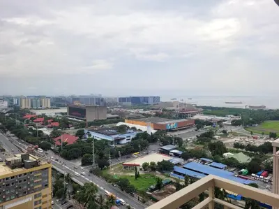 an overhead view of a city with a road and buildings at SMDC Coast Residences - The Happy Place in Manila