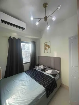 a bedroom with a bed with a ceiling fan at Mall of Asia Shore 3 near Airport Pasay Manila 1 Bedroom Wifi in Manila
