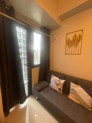a living room with a couch and a window at Mall of Asia Shore 3 near Airport Pasay Manila 1 Bedroom Wifi in Manila