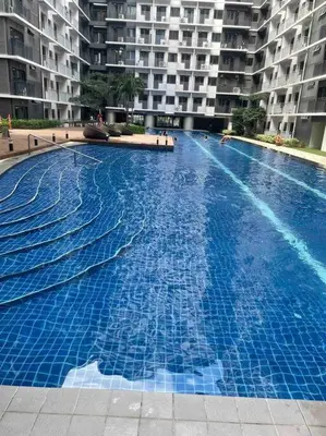 a large swimming pool in front of a building at Mall of Asia Shore 3 near Airport Pasay Manila 1 Bedroom Wifi in Manila