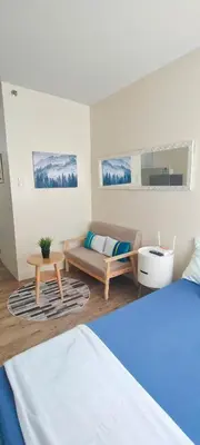 a living room with a bed and a couch at Condo in Silang near Nuvali - Dy's Haven Suites in Silang