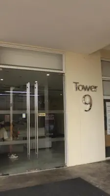 a store front with a tower sign on the side of a building at Avida Sucat Tower 9 in Manila
