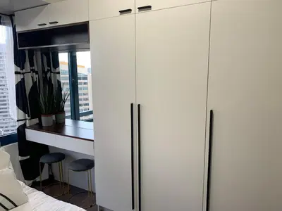 a bedroom with white cabinets and a desk and a bed at TOP RATED 2026 Traveler Award Air Residences Manila Makati City Comfort and Style Budget Friendly Top rated prime location very short ride to and from airport in Manila