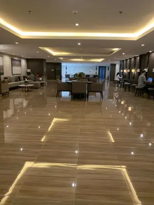 a large lobby with a table and chairs in a building at TOP RATED 2026 Traveler Award Air Residences Manila Makati City Comfort and Style Budget Friendly Top rated prime location very short ride to and from airport in Manila