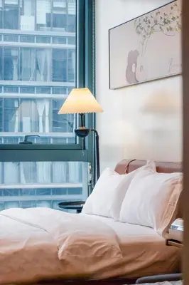 a bedroom with a bed and a window at Thompson Suites Queen Room, One Uptown Residences, XBOX & Netflix in Manila