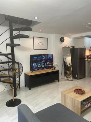 a living room with a tv and a shelf at Saphir Townhouse 5 to 6 pax rooftop terrace, Cavite in Imus