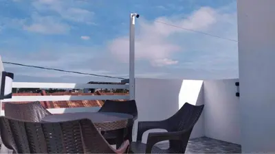 a patio with a table and chairs on a balcony at Saphir Townhouse 5 to 6 pax rooftop terrace, Cavite in Imus