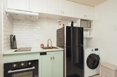 a kitchen with a black refrigerator and a dishwasher at Modern Luxe Condo Unit in Cavite in Imus