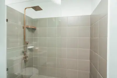 a bathroom with a shower with a toilet at Modern Luxe Condo Unit in Cavite in Imus