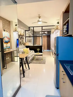 a kitchen and living room with a blue refrigerator at Aiza's Place in Shell Residences MOA in Manila