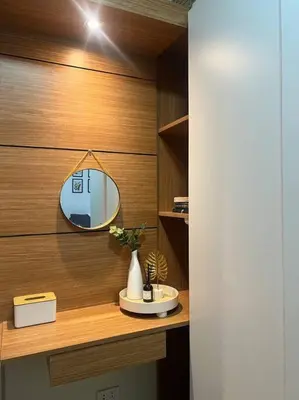 a bathroom with a mirror on a wooden wall at PSV NAIA T3 - Month of January - New Year 2026 PROMO Php 1,999 - 1 BR Interior Designed Unit in Manila