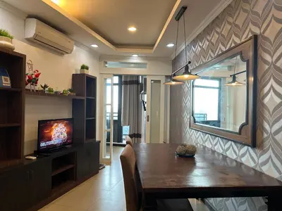 a living room with a dining room table and a mirror at Gramercy Residences 46th Floor 1 Bedroom Sunset View in Manila