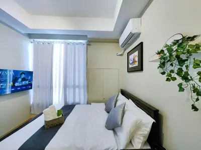 a bedroom with a white bed and a window at 1BR Condotel Suite at Sunshine100 City Plaza #SS01 in Manila