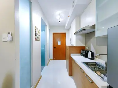 a kitchen with white counters and a stove top oven at 1BR Condotel Suite at Sunshine100 City Plaza #SS01 in Manila