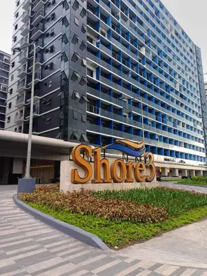 a store sign in front of a large building at JN Staycation at Shore 3 Mall of Asia in Manila