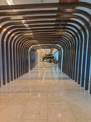 an empty hallway in a building with a ceiling at JN Staycation at Shore 3 Mall of Asia in Manila