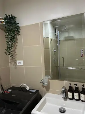 a bathroom with a sink and a mirror at JN Staycation at Shore 3 Mall of Asia in Manila