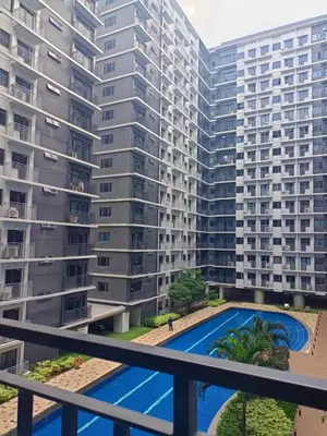 a view of two large apartment buildings from a balcony at JN Staycation at Shore 3 Mall of Asia in Manila