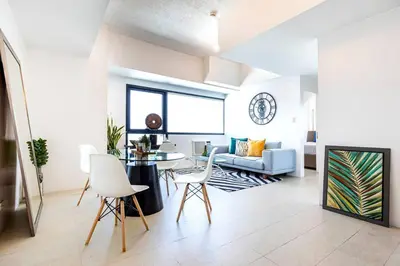 a living room with a table and a couch at Executive Suite - BSA Twin Towers, Ortigas Ctr in Manila