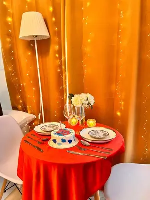 a table with a red table cloth and a cake on it at Mandaluyong Staycation in Manila