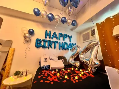 a bedroom with a happy birthday sign and balloons at Mandaluyong Staycation in Manila
