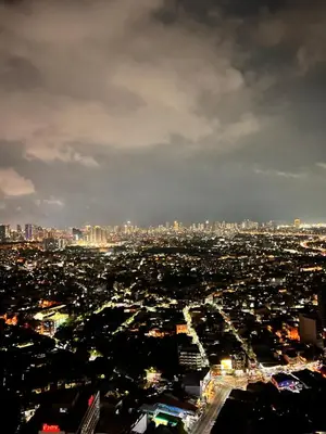 an aerial view of a city at night at Mandaluyong Staycation in Manila