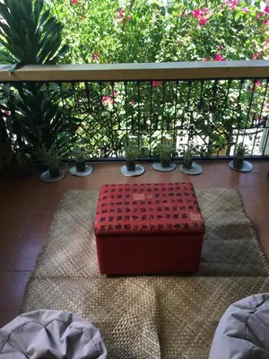 a red suitcase sitting on a rug on a balcony at Guesthouse Cavite in Dasmariñas