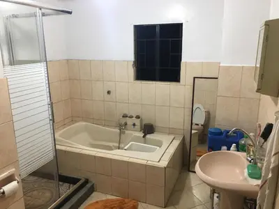a bathroom with a tub and a sink at Guesthouse Cavite in Dasmariñas