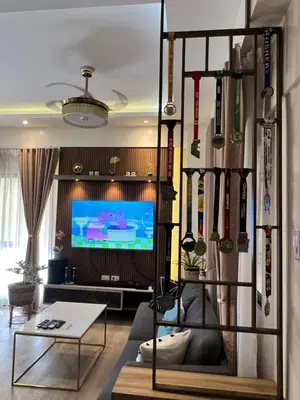 a living room with a couch and a tv at Penthouse Condo Unit near Airport NAIA in Manila