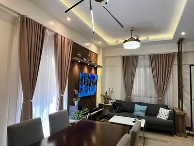 a living room with a table and a couch at Penthouse Condo Unit near Airport NAIA in Manila
