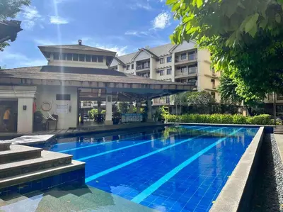 a large swimming pool in front of a building at Penthouse Condo Unit near Airport NAIA in Manila