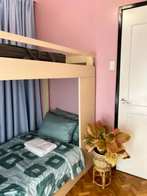 a bedroom with a bunk bed and a potted plant at Penthouse Condo Unit near Airport NAIA in Manila