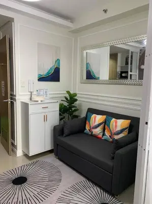 a living room with a couch and a mirror at POSH 1 BR Unit+ Netflix*WIFI @ Shore 2 in Manila
