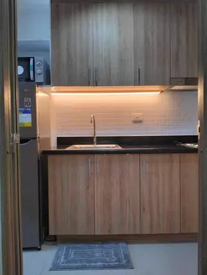 a kitchen with a sink and a refrigerator at POSH 1 BR Unit+ Netflix*WIFI @ Shore 2 in Manila