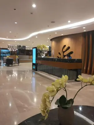 a lobby with a vase with yellow flowers on the floor at POSH 1 BR Unit+ Netflix*WIFI @ Shore 2 in Manila