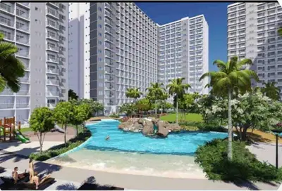 a swimming pool in a resort with tall buildings at POSH 1 BR Unit+ Netflix*WIFI @ Shore 2 in Manila